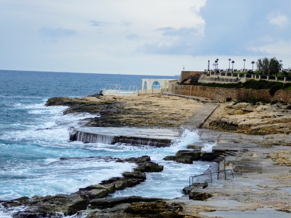 Sandstone rock slabs acting as a beach in Sliema, Malta 